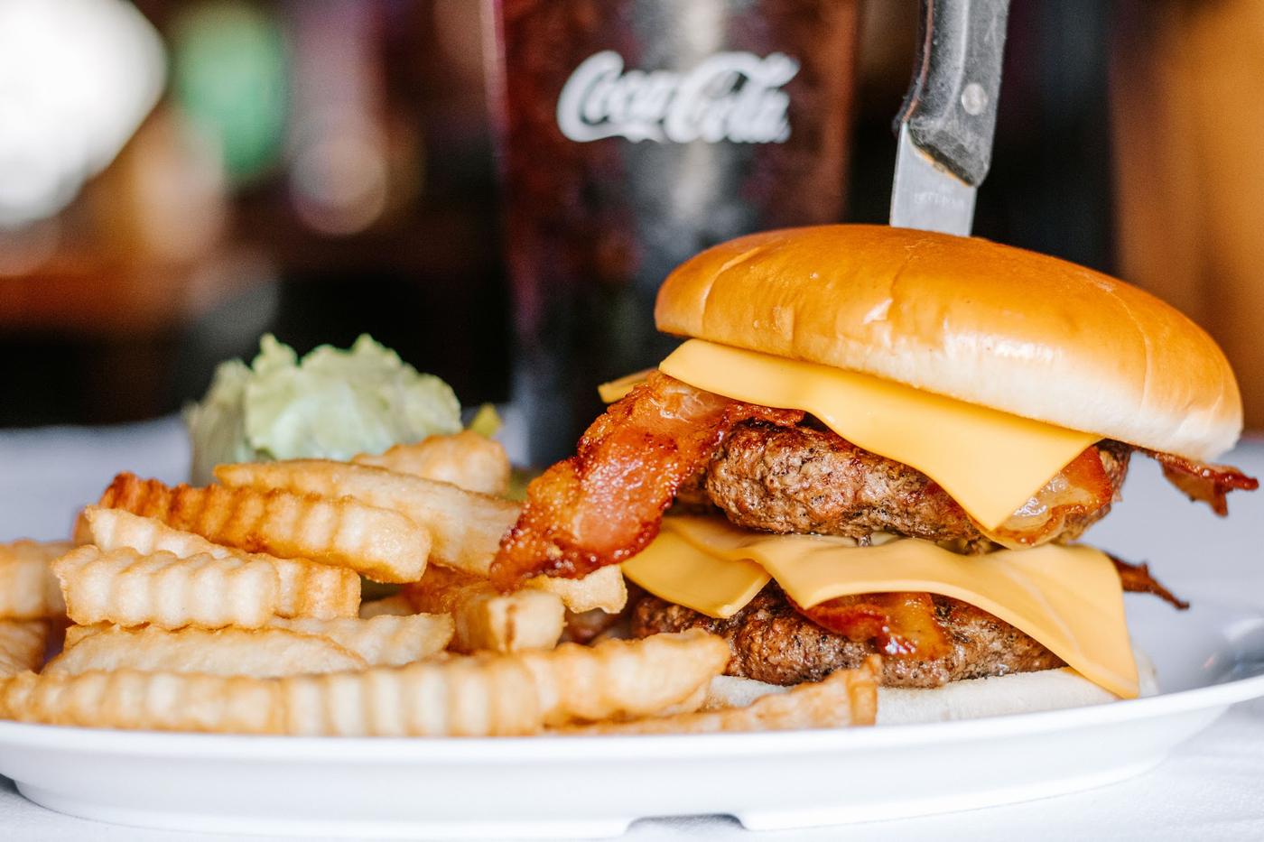 A double bacon cheeseburger with crinkle cut fries and coleslaw